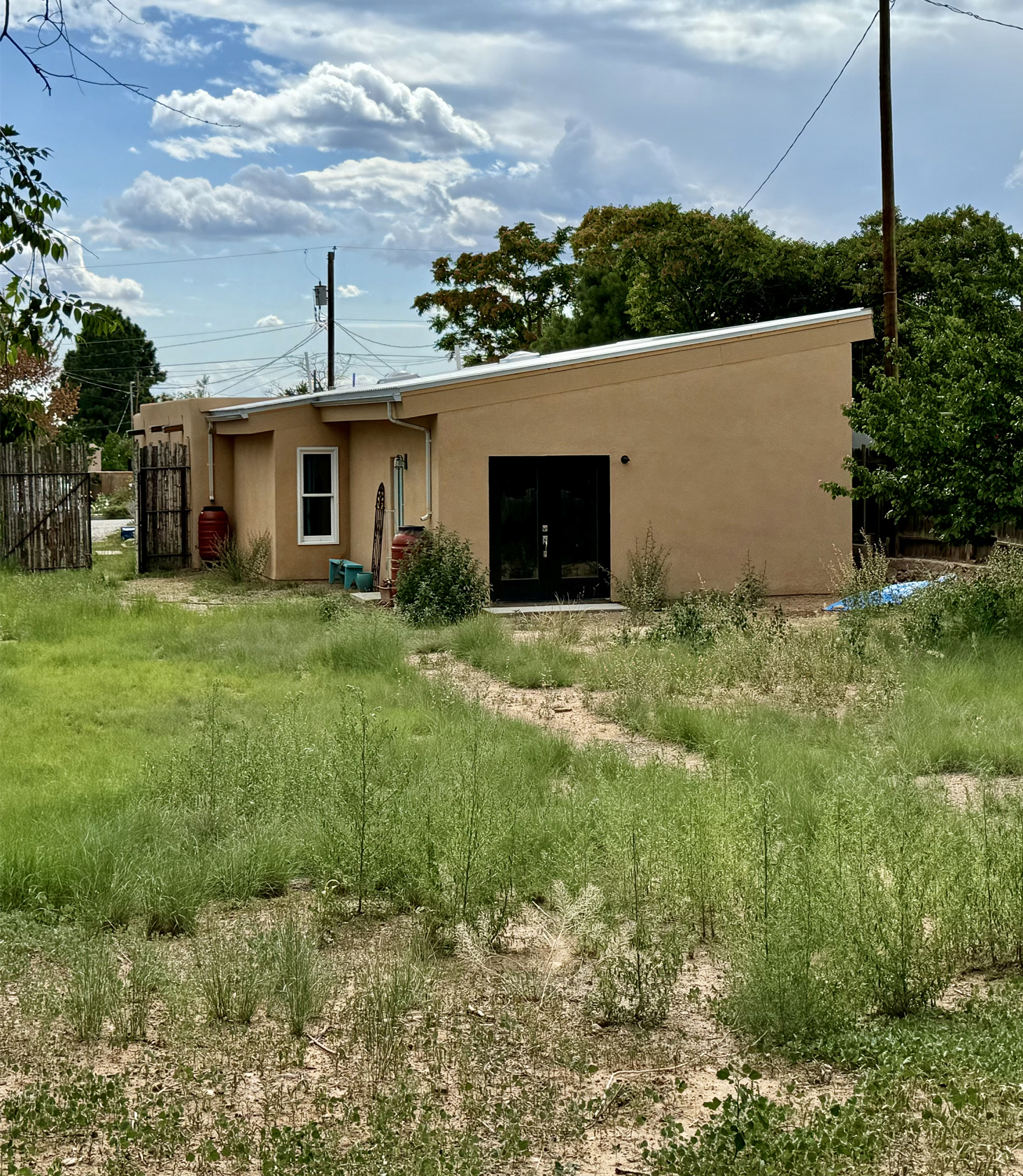 View from back of yard, you can see the slope of the roof