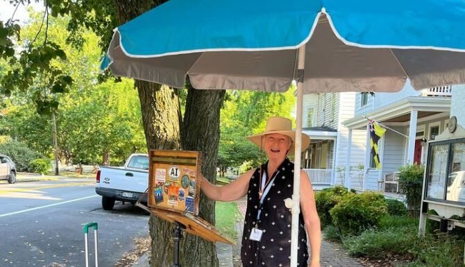 Rhonda Ford set up to paint in front of The Treasure Chest in Oxford during Plein Air Easton.